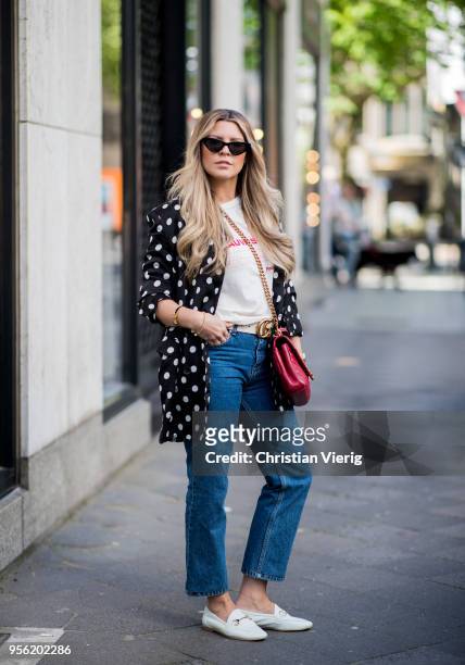 Verena Ahmann wearing a white black satin dots long blazer from Mango, beige red shirt and 7/8 denim pants Sincerely Jules, Off White coloured shoes...