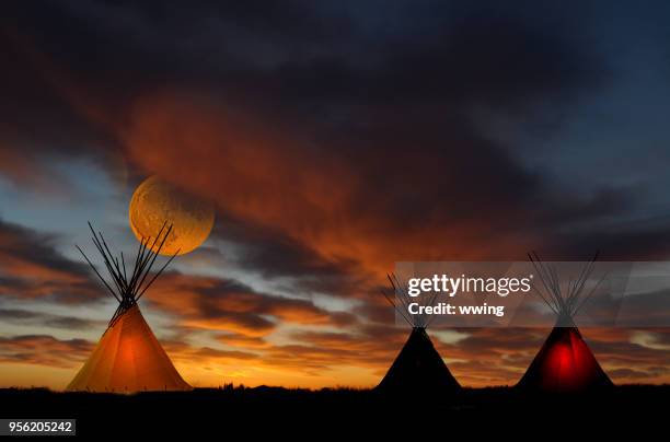 teepee camp at sunset with full moon - tipi stock pictures, royalty-free photos & images