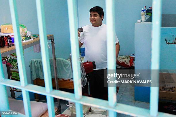 Sajid Ampatuan, a suspended governor of the southern Maguindanao province, stands inside his detention cell holding a small copy of the Koran at the...