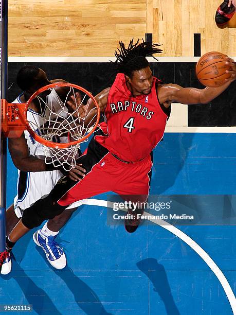 Chris Bosh of the Toronto Raptors grabs a rebound against the Orlando Magic during the game on January 6, 2010 at Amway Arena in Orlando, Florida....