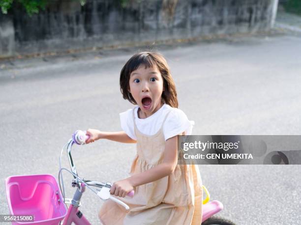 a girl riding a bicycle - girl bike stock pictures, royalty-free photos & images