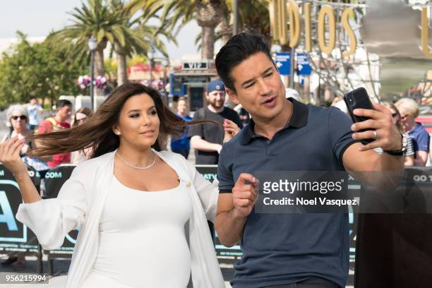 Mario Lopez poses with Eva Longoria visits "Extra" at Universal Studios Hollywood on May 8, 2018 in Universal City, California.
