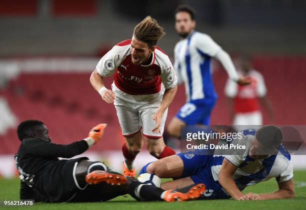 Vlad Dragomir of Arsenal is challenged by Mouhamed Mbaye and Diogo Queiros of Porto during the match between Arsenal and FC Porto at Emirates Stadium...