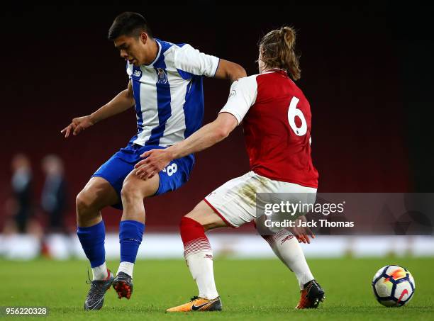 Ben Sheaf of Arsenal U/23 and Santiago Vera of Portu U23 compete for the ball during the Premier League International Trophy between Arsenal U23 and...