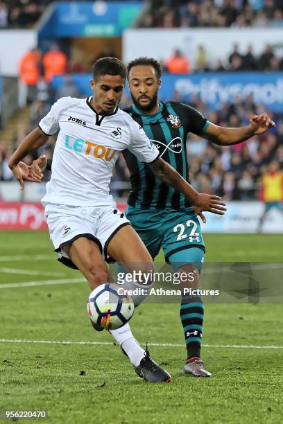Kyle Naughton of Swansea City challenged by Nathan Redmond of Southampton during the Premier League match between Swansea City and Southampton at The...