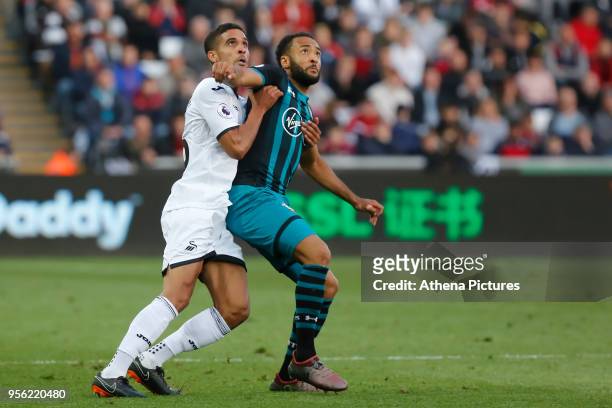 Kyle Naughton of Swansea City challenged by Nathan Redmond of Southampton during the Premier League match between Swansea City and Southampton at The...