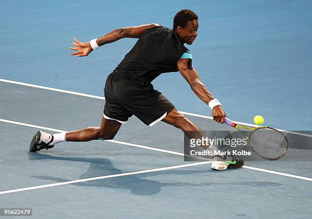 Gael Monfils of France stretches to play a backhand in his quarter final match against James Blake of the USA during day five of the Brisbane...