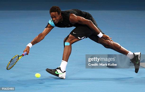 Gael Monfils of France stretches to play a forehand in his quarter final match against James Blake of the USA during day five of the Brisbane...