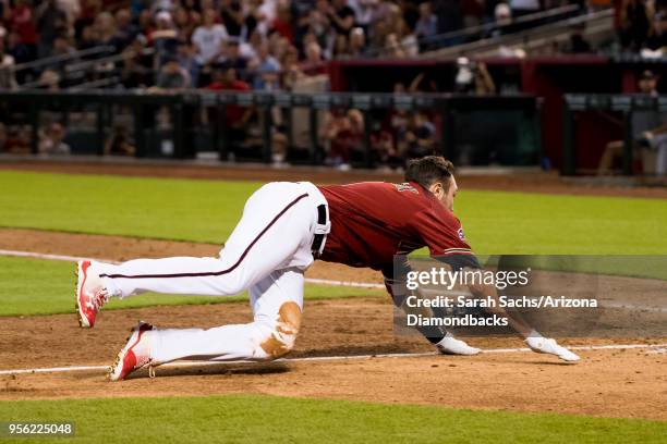 Pollock of the Arizona Diamondbacks slides into home plate to score on an interference error against Alex Bregman of the Houston Astros in the sixth...