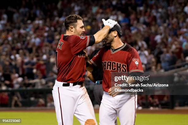 Pollock of the Arizona Diamondbacks celebrates with Daniel Descalso after scoring on an interference call against Alex Bregman of the Houston Astros...