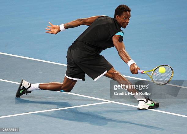 Gael Monfils of France stretches to play a backhand in his quarter final match against James Blake of the USA during day five of the Brisbane...