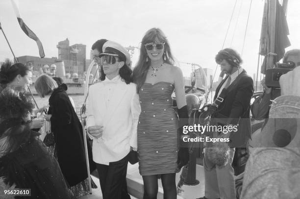 English journalist and television executive Janet Street-Porter with boyfriend Tony James, of pop group Sigue Sigue Sputnik, at a party on a Thames...