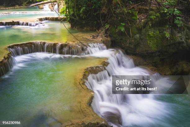 long exposure of kuang si waterfalls - kuang si falls stock pictures, royalty-free photos & images