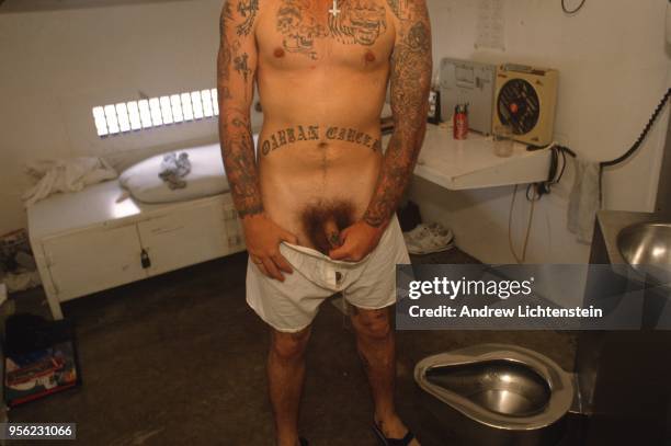 Prisoner shows off his white supremacist tattoos at the historical Eastham Prison on June 9, 1997 in Lovely, Texas.