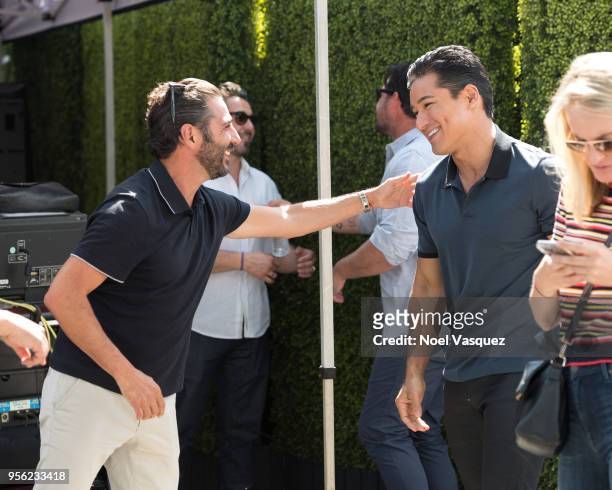 Jose Baston and Mario Lopez visit "Extra" at Universal Studios Hollywood on May 8, 2018 in Universal City, California.