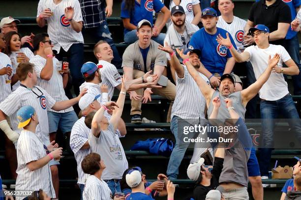 Fans try to catch the two run home run ball hit by Justin Bour of the Miami Marlins against the Chicago Cubs during the first inning at Wrigley Field...