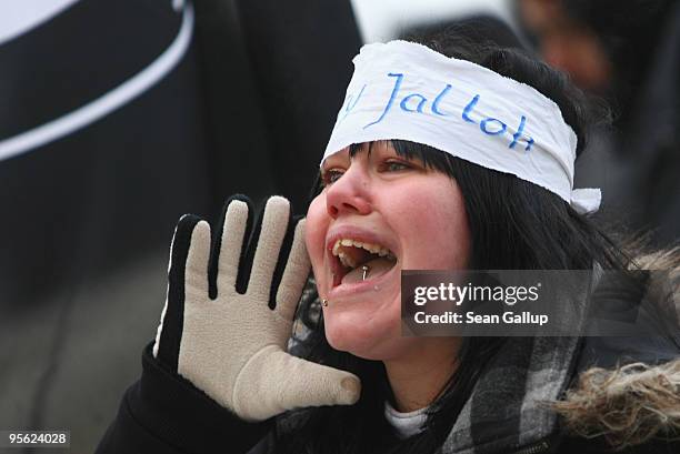 Young woman wearing a headband that reads: "Oury Jalloh" shouts slogans during a demonstration marking the ruling of Germany's Federal High Court in...