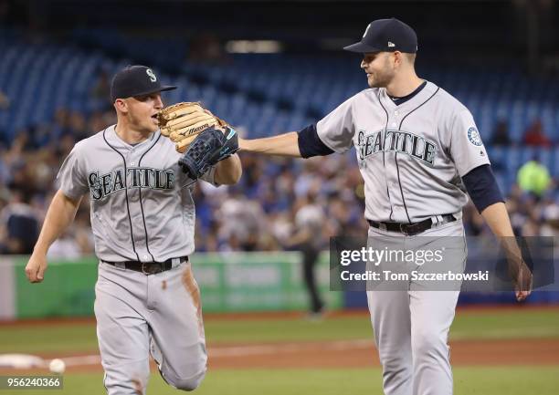 James Paxton of the Seattle Mariners congratulates Kyle Seager after making a solid defensive play to preserve his no-hitter in the seventh inning...