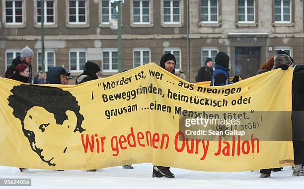 Protesters carrying a banner that reads: "We Commemorate Oury Jalloh" march in a demonstration marking the ruling of Germany's Federal High Court in...