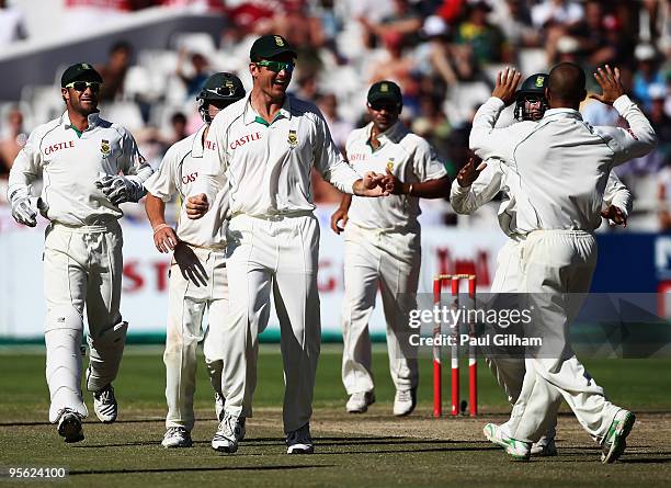 Graeme Smith of South Africa and his team-mates celebrate Jean-Paul Duminy taking the wicket of Paul Collingwood of England for 40 runs when he was...