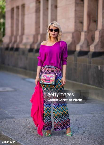 Gitta Banko wearing multi-colored trousers by Missoni, ultra violet off-shoulder cashmere sweater and pink cashmere scarf by Lamaii Cashmere, lime...