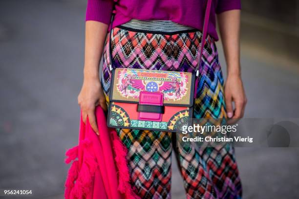 Gitta Banko wearing multi-colored trousers by Missoni, ultra violet off-shoulder cashmere sweater and pink cashmere scarf by Lamaii Cashmere, lime...