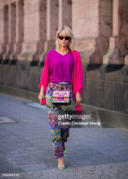 Gitta Banko wearing multi-colored trousers by Missoni, ultra violet off-shoulder cashmere sweater and pink cashmere scarf by Lamaii Cashmere, lime...