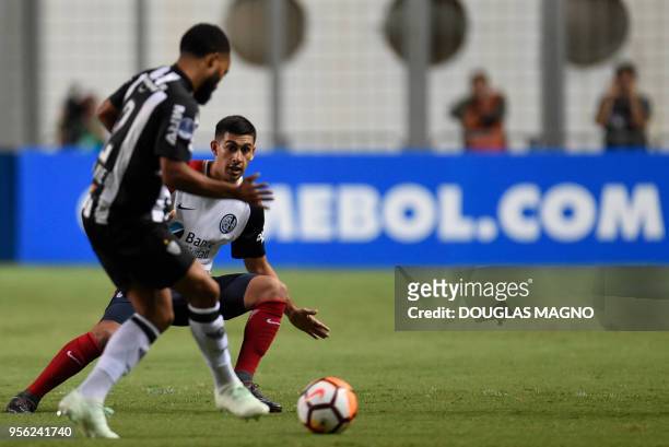 Samuel Xavier of Brazil's Atletico Mineiro, vies for the ball with Franco David Moyano of Argentina's San Lorenzo, during their 2018 Copa...