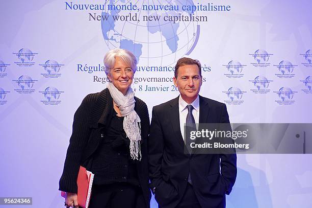 Eric Besson, France's minister of immigration, right, welcomes Christine Lagarde, France's finance minister, at the " New World, New Capitalism"...