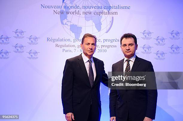 Eric Besson, France's minister of immigration, left, welcomes Bozidar Delic, Serbia's science and technology development minister, at the " New...