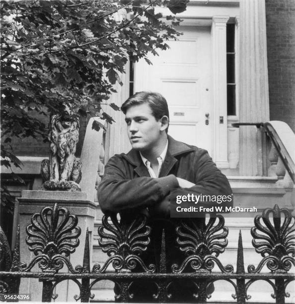 Portrait of American poet, editor, and critic Bill Berkson as he leans on the ironwork railing in front of the staircase to number 6 Washington...
