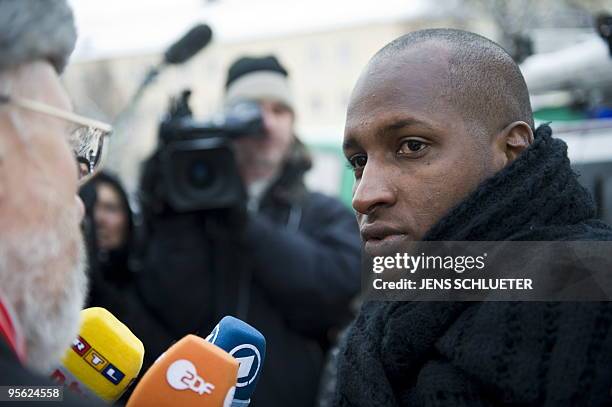 Mamadou Saliou Diallo, brother of Oury Jalloh, speaks with tv reporters at a demonstration in the eastern German city of Dessau on January 7, 2010....