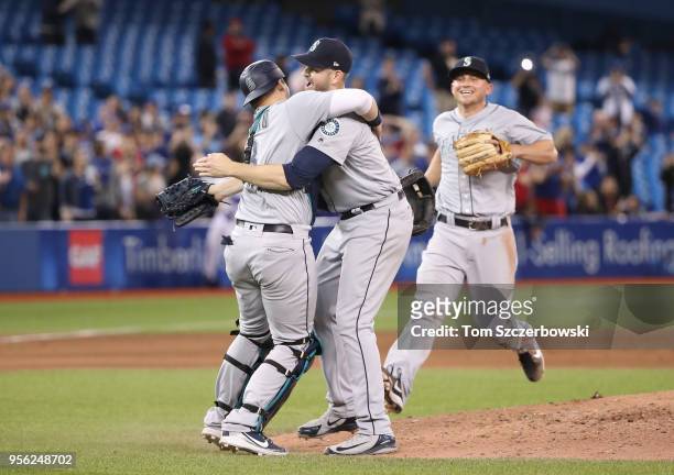 James Paxton of the Seattle Mariners is congratulated by Mike Zunino and teammates after throwing a no-hitter during MLB game action against the...
