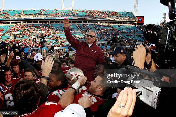 Head coach Bobby Bowden of the Florida State Seminoles is carried off the field by his players after defeating the West Virginia Mountaineers during...