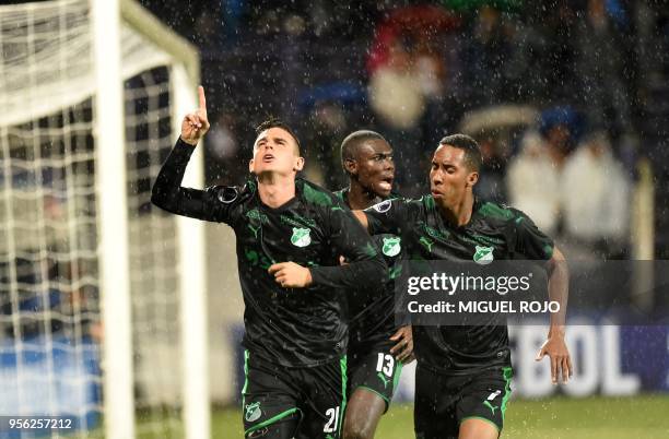 Colombia's Deportivo Cali midfielder Nicolas Benedetti celebrates with midfielders Jhon Mosquera and Didier Delgado after scoring against Uruguay's...