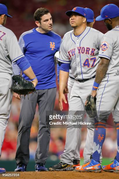 New York Mets trainer attends to Hansel Robles of the New York Mets who would leave the game with an injury during the seventh inning against the...