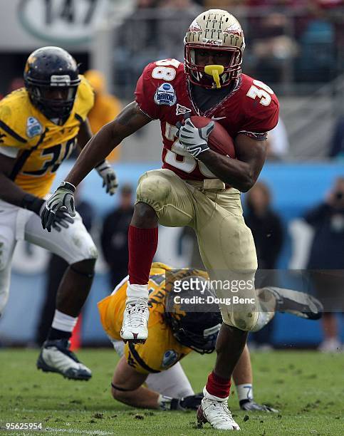 Running back Jermaine Thomas of the Florida State Seminoles looks for room to run against the West Virginia Mountaineers during the Konica Minolta...