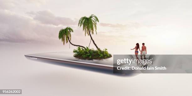 couple stand together looking at virtual idyllic tropical island on smart phone - 無人島 ストックフォトと画像