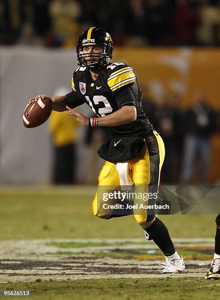 Ricky Stanzi of the Iowa Hawkeyes rolls out of the pocket against the Georgia Tech Yellow Jackets during the FedEx Orange Bowl at Land Shark Stadium...