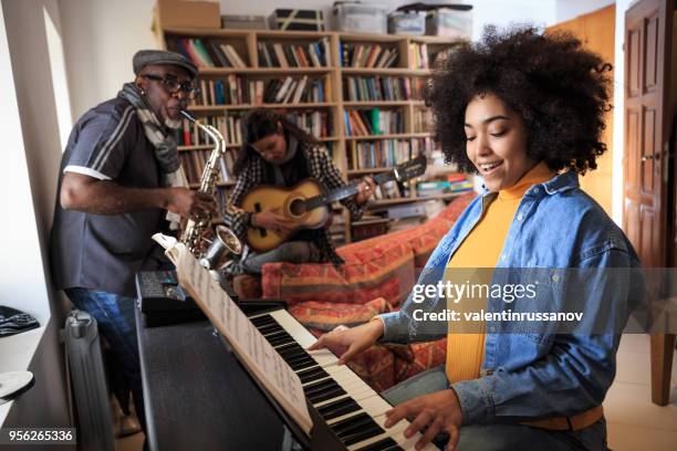 group making jam session at home - woman in guitar making studio stock pictures, royalty-free photos & images