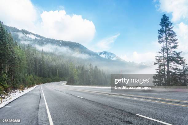 empty tarmac road in mt. rainier national park; - empty road mountains stock pictures, royalty-free photos & images
