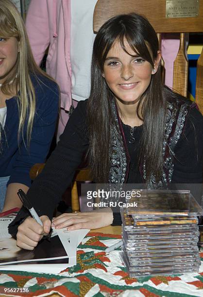 Ali Lohan signing the CD "Totally Awesome Christmas" on which she makes her singing debut with the single "Rockin' Around The Christmas Tree"