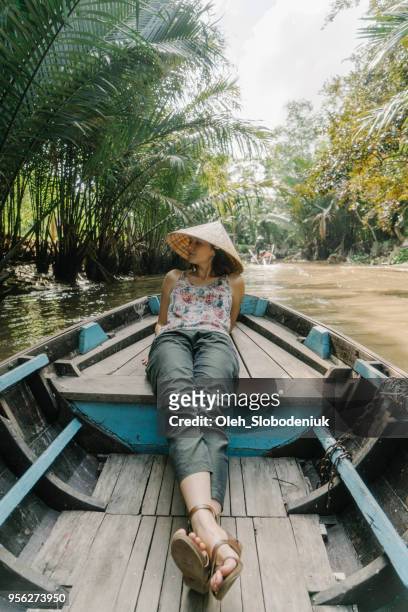 woman riding on boat through mekong delta and floating market - hot vietnamese women stock pictures, royalty-free photos & images