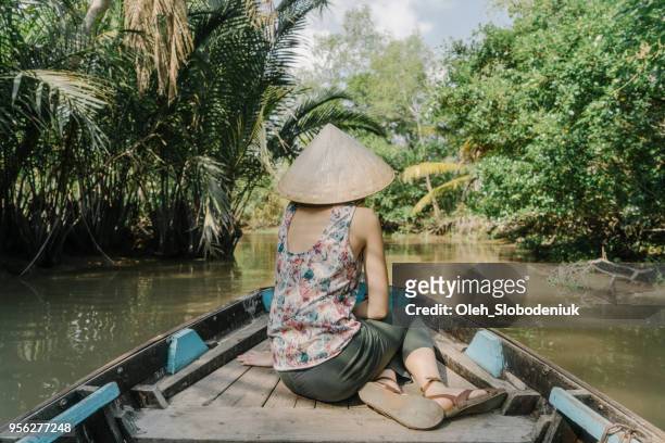 woman riding on boat through mekong delta - hot vietnamese women stock pictures, royalty-free photos & images