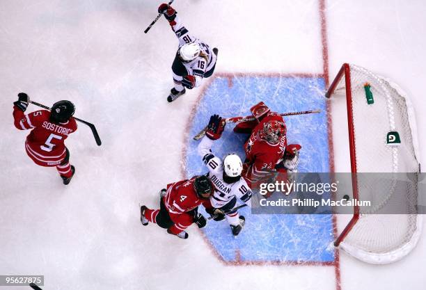 Kelli Stack and Meghan Duggan of Team USA celebrate a goal against Colleen Sostorics, Becky Kellar and Charline Labonte of Team Canada at Scotiabank...