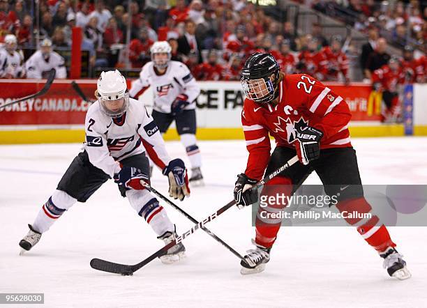 Hayley Wickenheiser of Team Canada skates with the puck against Jenny Potter of Team USA at Scotiabank Place on January 1, 2010 in Ottawa, Canada.
