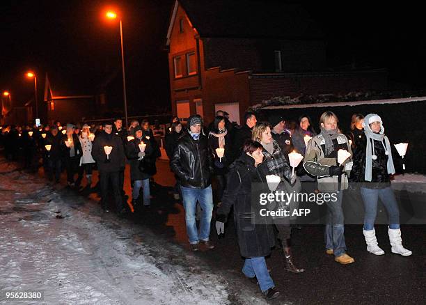 People attend a silent march held in memory of a murdered couple Shana Appeltans and Kevin Paulus, in Loksbergen, January 7, 2010. Niehgbour Ronald...