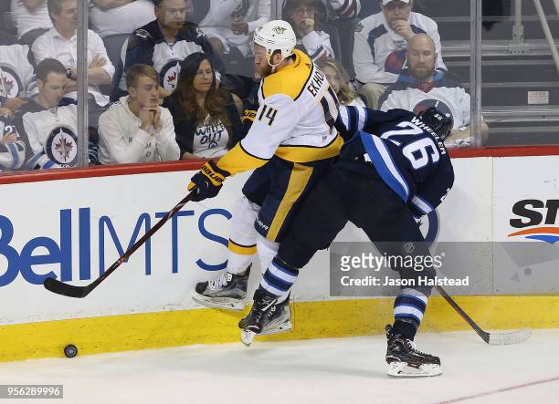 Blake Wheeler of the Winnipeg Jets hits Mattias Ekholm of the Nashville Predators in Game Six of the Western Conference Second Round during the 2018...