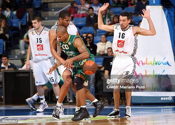 Omar Cook, #00 of Unicaja competes with Ludovic Vaty, #14 of Entente Orleanaise during the Euroleague Basketball Regular Season 2009-2010 Game Day 9...