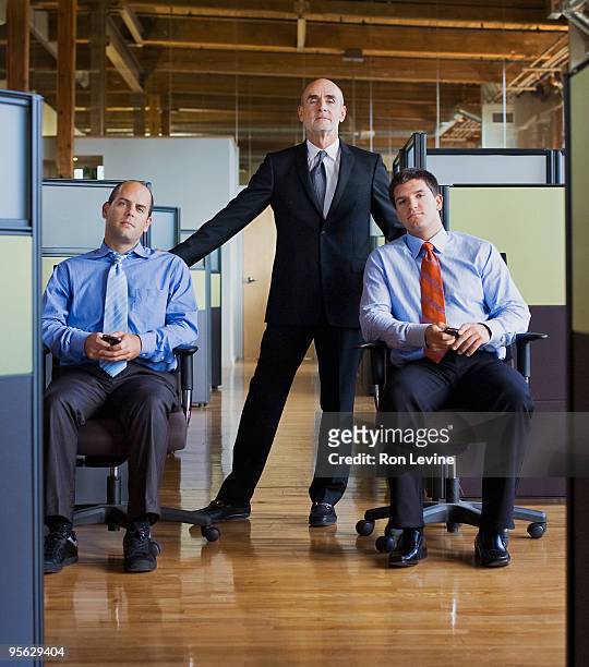 senior executive with his junior executive team  - moving down to seated position stock pictures, royalty-free photos & images